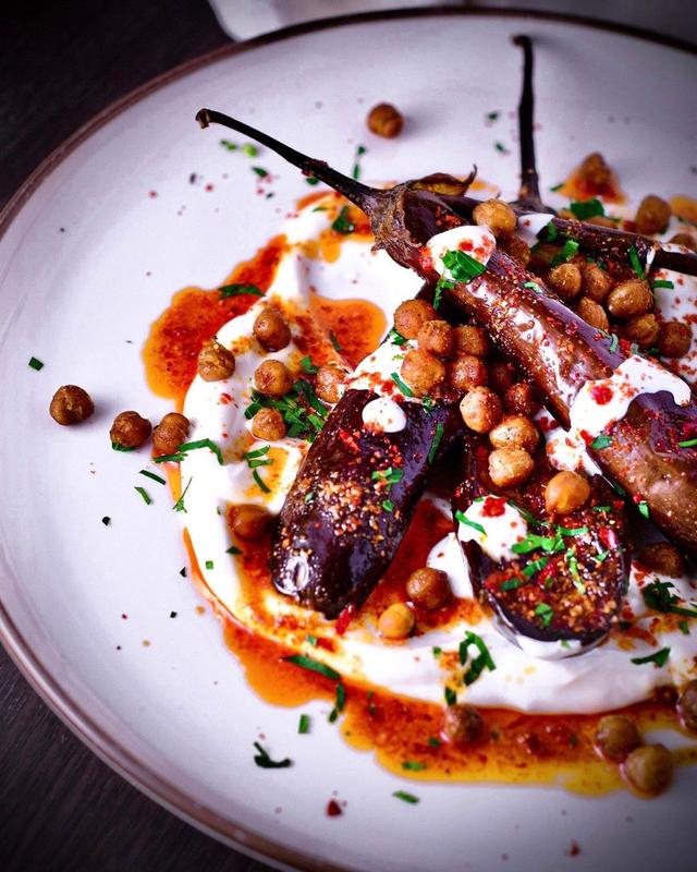 Oven-roasted eggplant with Turkish yoghurt, harissa butter and crispy chickpeas